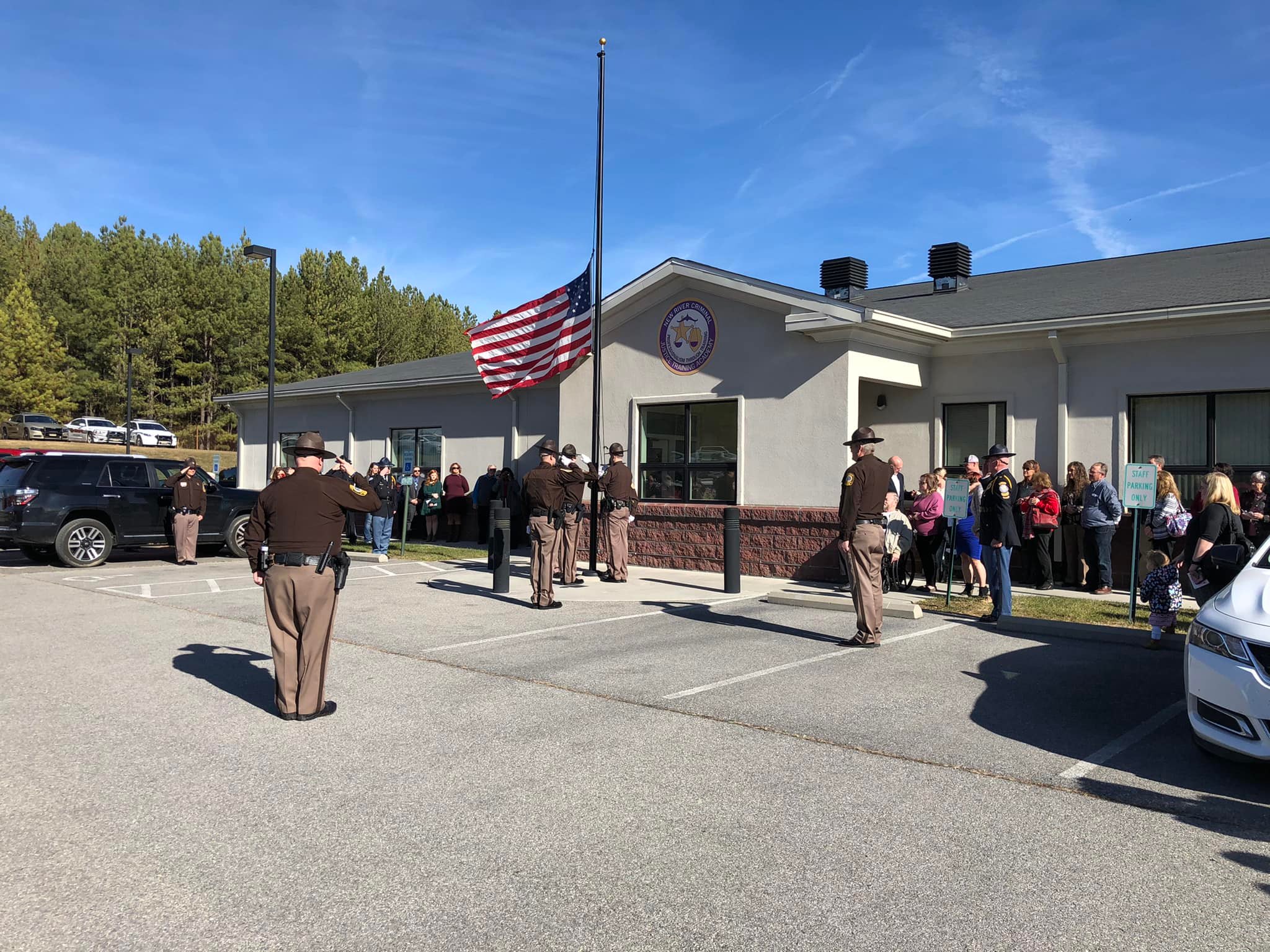 Officers saluting an American flag being raised.